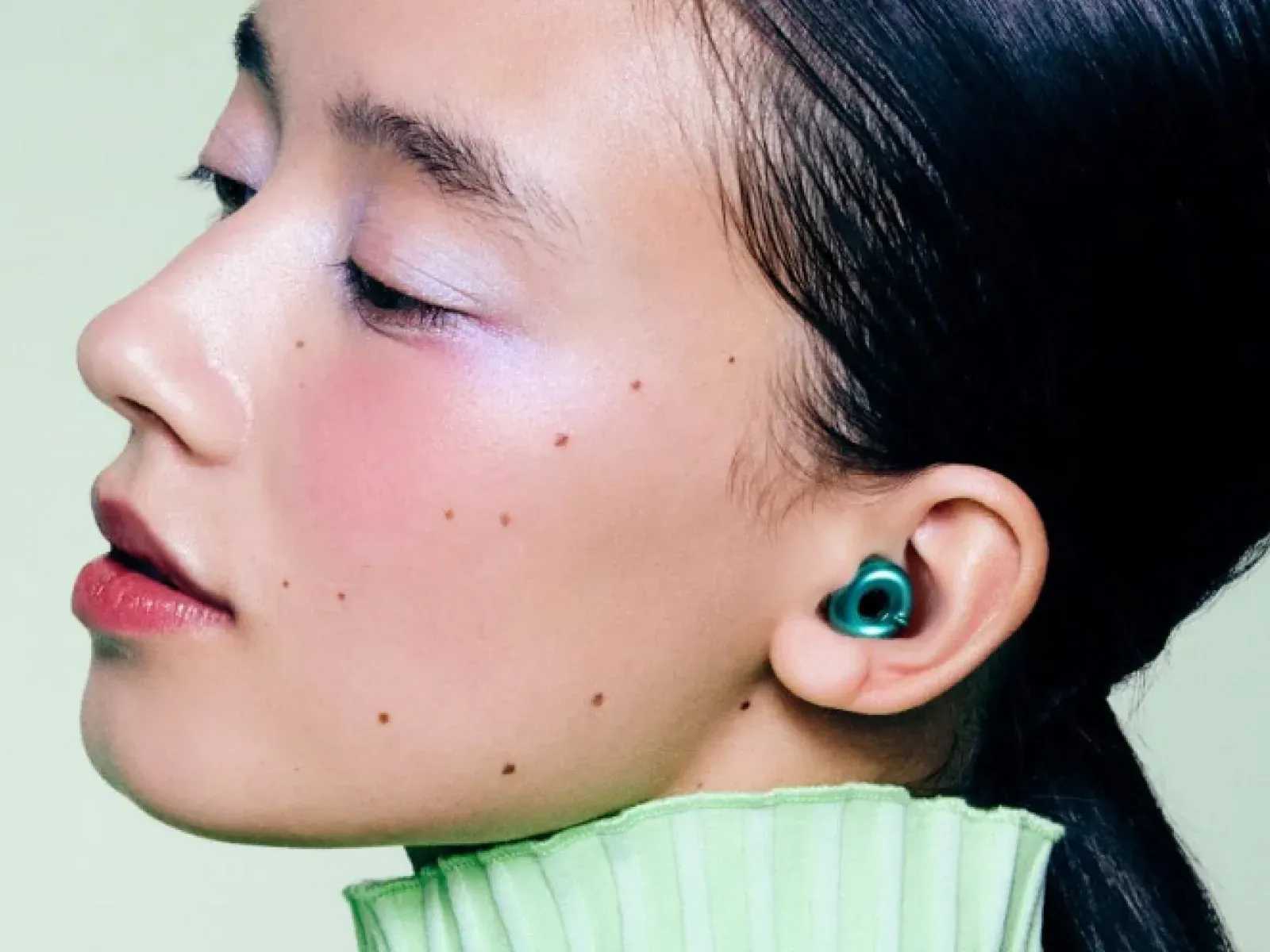 A woman wearing a Loop earplug